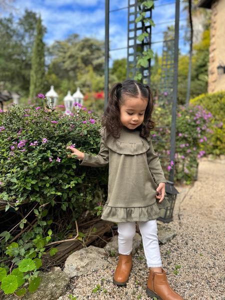 girl stood in sunny garden wearing leggings in white color with elasticated waist and ankle trim and dress