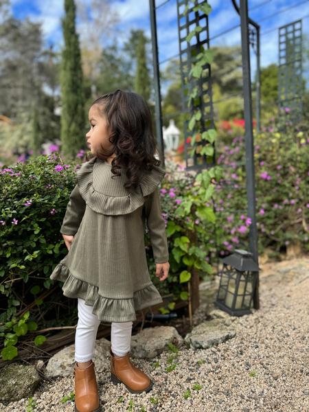 girl stood in sunny garden wearing leggings in white color with elasticated waist and ankle trim and dress